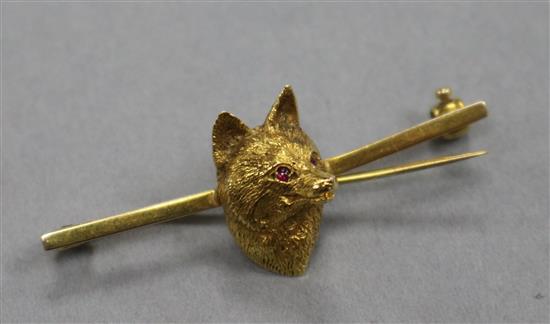 A yellow metal and gem set fox head bar brooch, 42mm.
